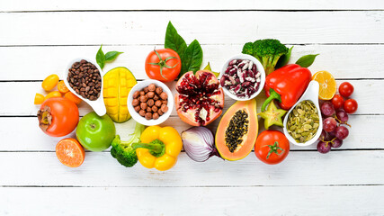 Vegetables, fruits, beans and nuts on a white background. Background Organic food. Top view. Free space for your text.
