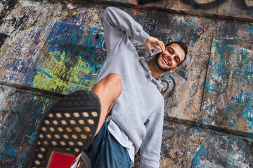 young man with mobile phone and standing in front of the camera