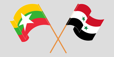 Crossed and waving flags of Myanmar and Syria