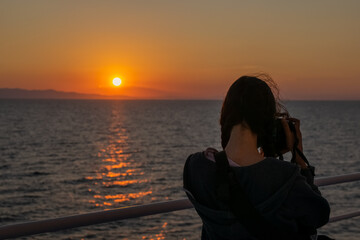 Fototapeta premium Sunste over the Mediterranean horizont in summer seen from a boat with Athos mountain