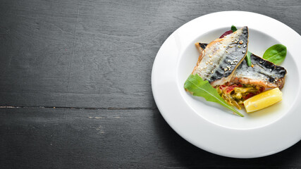 Baked mackerel fillet with vegetables. Top view. Free space for your text.