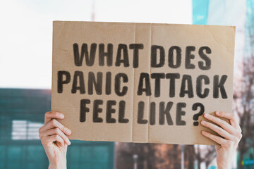 The question " What does panic attack feel like? " on a banner in men's hand with blurred background. Sickness. Physiology. Illness. Nervous