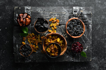 Set of dried fruits. Raisins, cranberries, dates and prunes. Top view. Free space for your text.