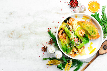 Salad of shrimp, olives, pine nuts and lettuce. Top view. Free space for text.