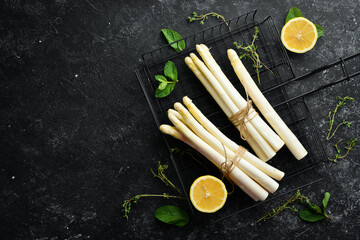 Organic food. White asparagus on a black background. Healthy food. Top view. Free space for your...