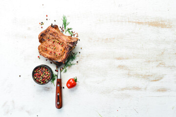 Steak with bone on a fork. Barbecue menu. Top view.