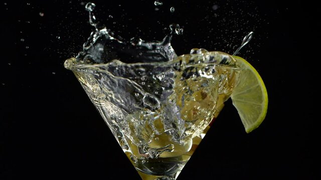 Super Slow motion shot of ice cube splashing into Dry Martini Drink