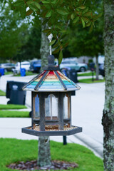 bird feeding station in front of a house