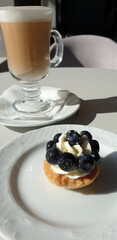 Cup with coffee latte and dessert