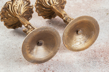 Antique candlesticks on concrete background.