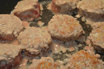 Cutlets on frying pan.