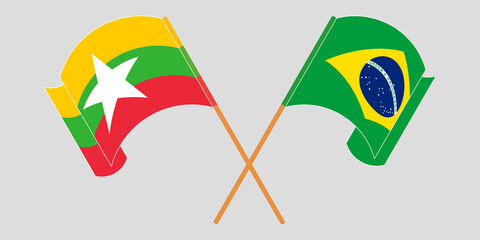 Crossed and waving flags of Myanmar and Brazil