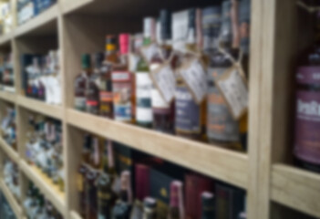 Blurred abstract background of shelf in supermarket. Alcohol showcase blurred background.