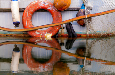 Old, weathered nautical items on the side of a fishing boat 