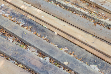 Heap of long wooden boards for the construction and improvement of the yard