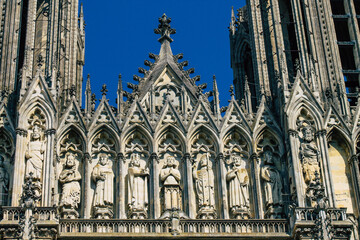 Fototapeta premium View of the exterior facade of the Roman Catholic Notre Dame de Reims Cathedral, a historical monument in the Grand Est region of France and one of the oldest in Europe