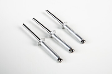 Aluminum construction rivets on a white background