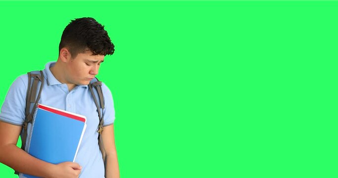 Upset schoolchild with backpack  on green screen background