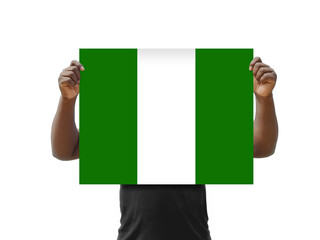 African man holding the Nigerian flag over his face, on a white background
