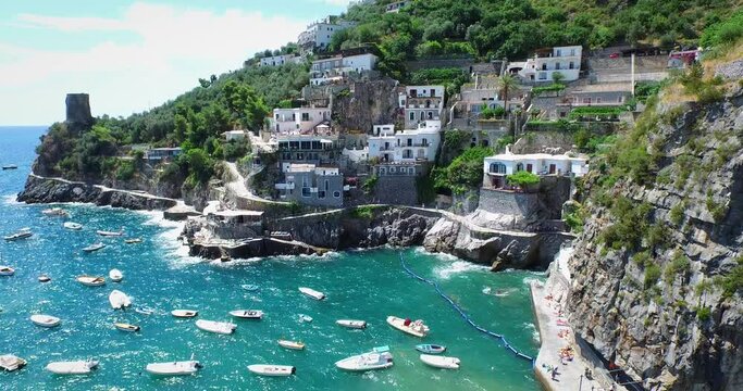 Boats off coastal town in Italy, aerial