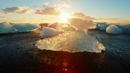 Sun sets over Okulsarlon Beach in Iceland, slow motion