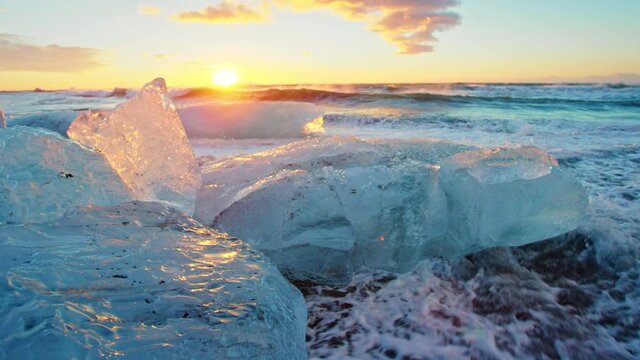 Close up, bits of ice on Okulsarlon Beach at sunset