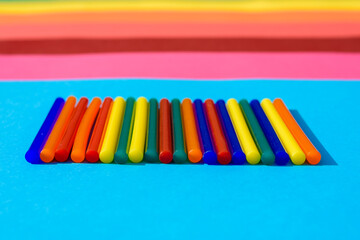 Colorful background of plastic bars, silicone glue, on a background of colored lines.