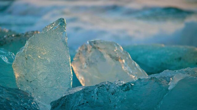 Close up, bits of iceberg on Okulsarlon Beach at sunset