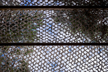 White camouflage military net as a roof to protect from the sun.