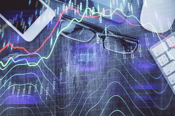 Multi exposure of forex graph hologram over desktop with phone. Top view. Mobile trade platform...
