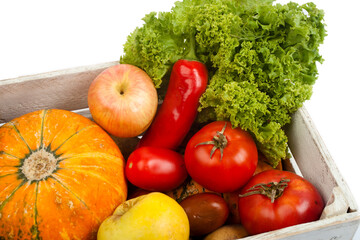 fresh vegetables of a new crop in a wooden box in isolation on a white background top view