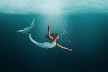 Underwater Mermaid Dancing Gracefully in the Ocean - 378226160