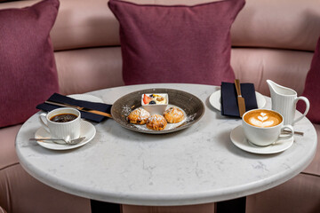Coffee morning and scone in cafe and city view on window