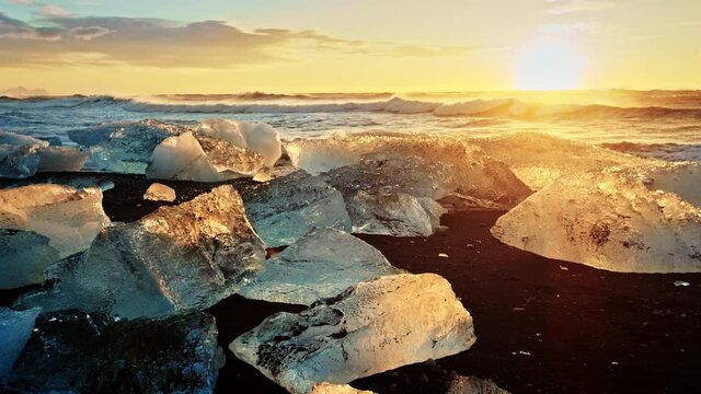 Okulsarlon Beach icebergs at sunset, slow motion close up