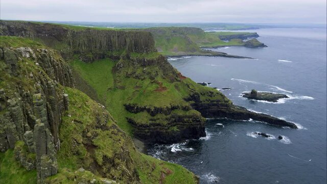 Wide aerial, coastal cliffside in Ireland