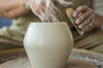 Woman making pottery on the wheel