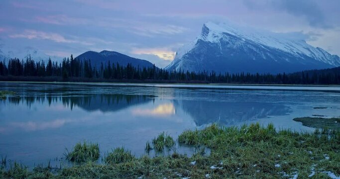 Wide aerial, sunset over mountain lake in Banff National Park
