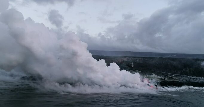 Slow motion lava flowing into ocean, aerial