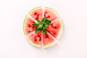 Watermelon pizza slices with mint leaves on white background. Top view