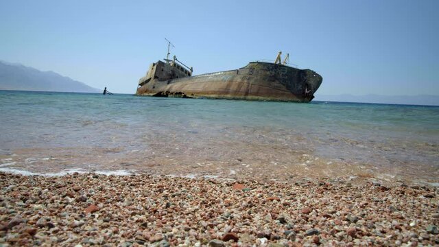 Low angle, shipwreck off beach in Saudi Arabia