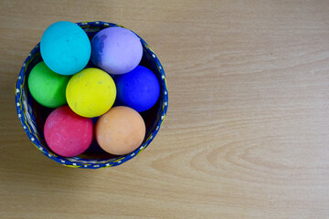 Easter eggs in the Basket on Wooden Table at morning day.
