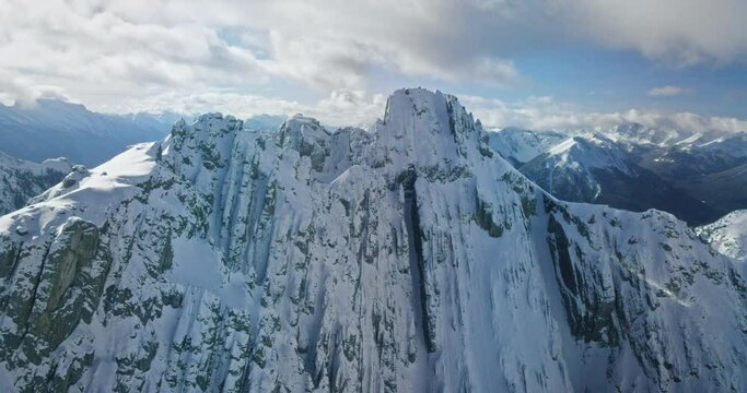 Wide aerial, snowy mountain ridge in Banff National Park