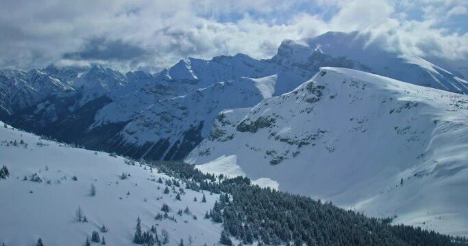 Wide aerial, snowy mountain landscape in Banff National Park