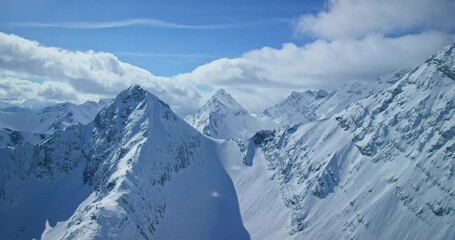 Helicopter pov, mountains covered in snow in Banff National Park