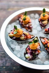 Ceviche over clam. Peruvian food in the Mediterranean of Majorca Island.