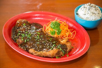 Milanese with carrot and sauce. Asian food.