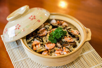 Sautéed rice and seafood with vegetables. Asian food.