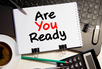 The question Are You Ready in red text on a yellow sticky note attached to a green notice board as a reminder