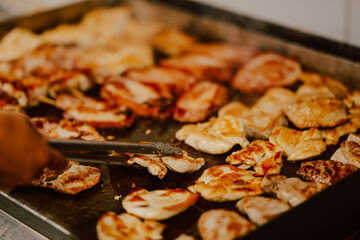 Delicious meat is baked in the kitchen of the restaurant. Preparing meat for guests