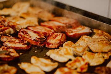 Delicious meat is baked in the kitchen of the restaurant. Preparing meat for guests